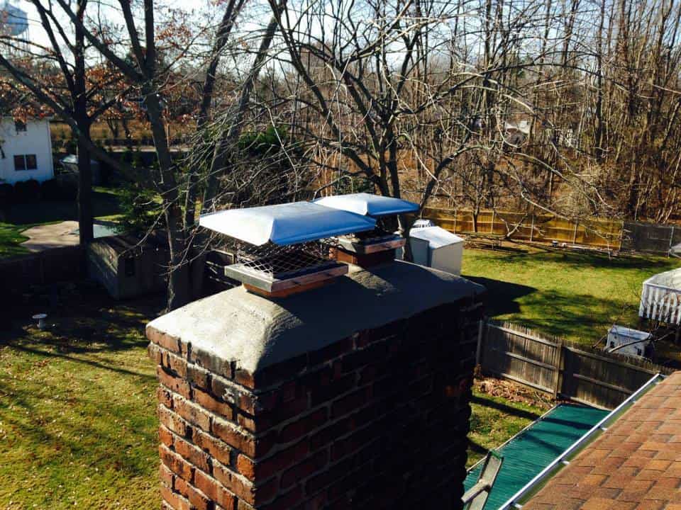 A Chimney with silver cap on top of it. Chimney Services Nassau County, NY