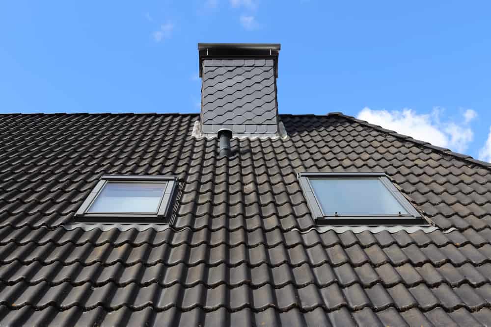 Roof Window In Velux Style With Black Roof Tiles Chimney Installation Nassau County, NY